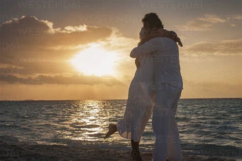 couple hugging on the beach